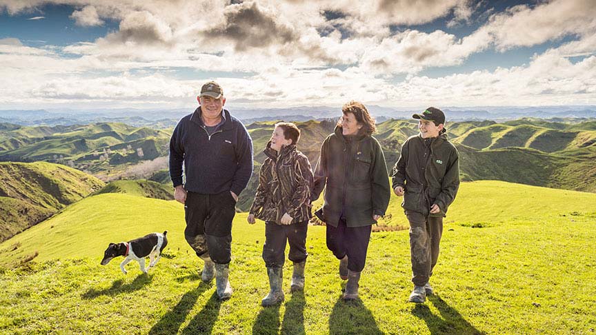 family and dog walking on farm