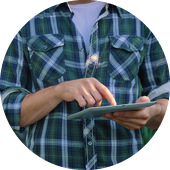 person in checked shirt using tablet 