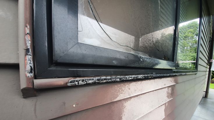 fire damaged window and external wall of motel building 