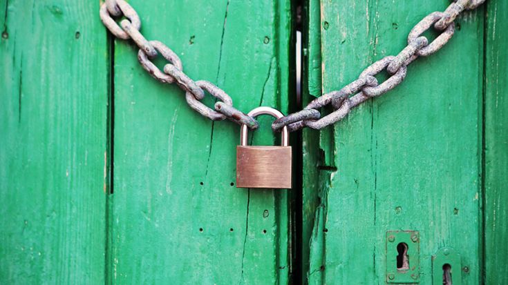 padlock and chain on green shed door 