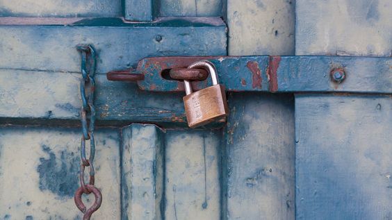 padlock on latch of blue shed door