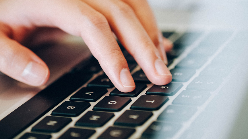 image of hand on laptop