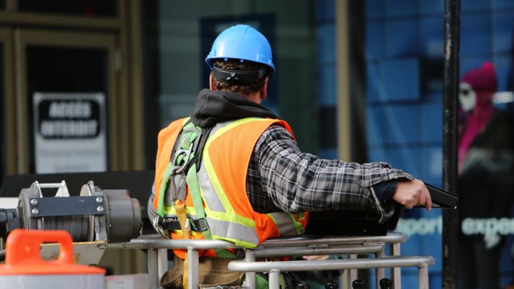 man in high vis vest on construction site 
