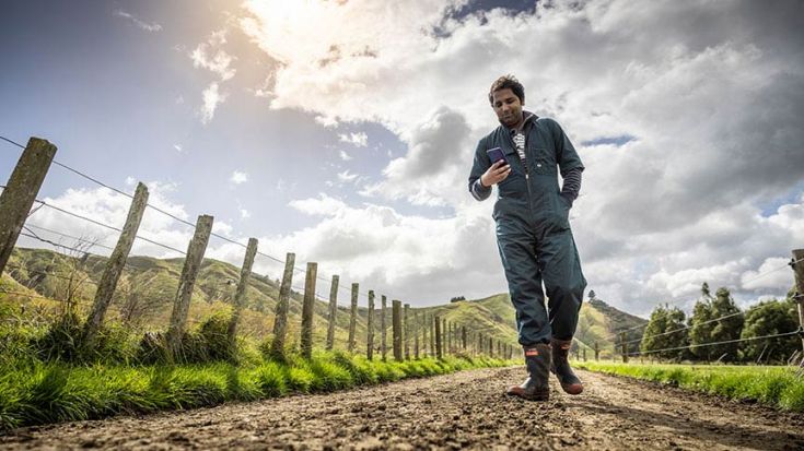 farmer in coveralls walking on farm