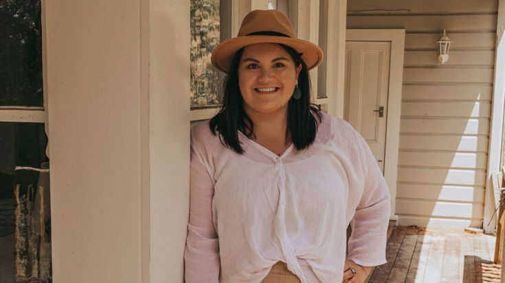 Leah Small leaning against a doorframe