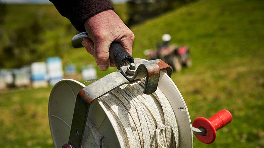 hand holding electric fencing reel