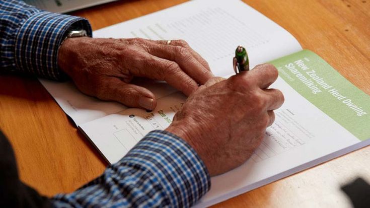 close up of someone filling in form at table 