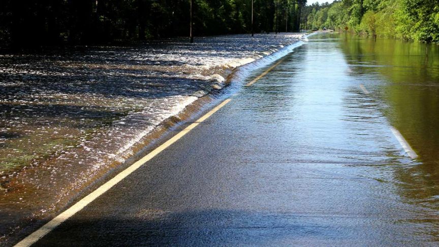 waters flooding over road 