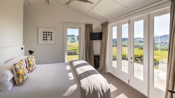 bedroom with sun coming through the windows 