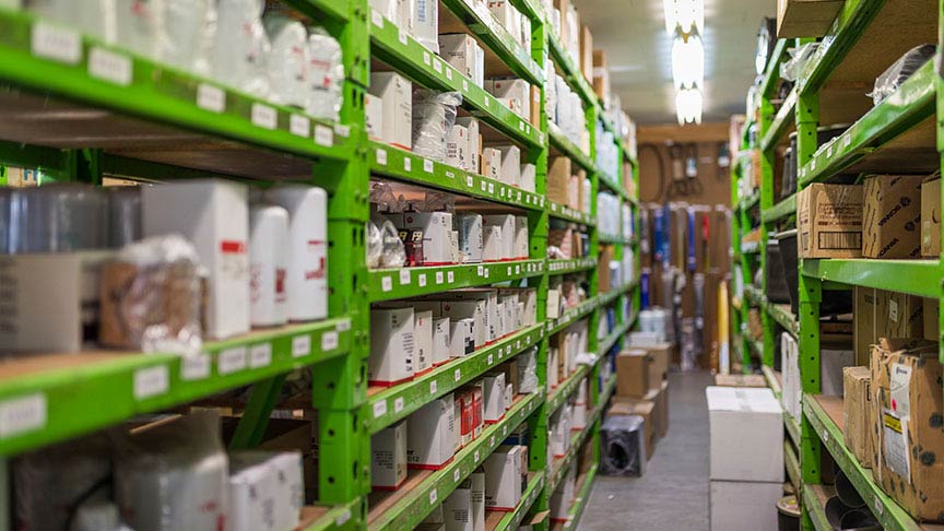 green metal stock shelves with product on them 