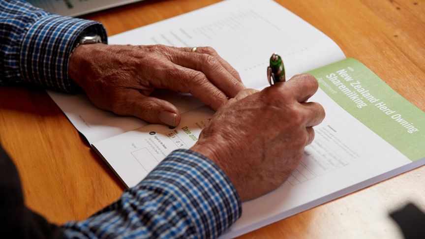 close up of hands signing document 