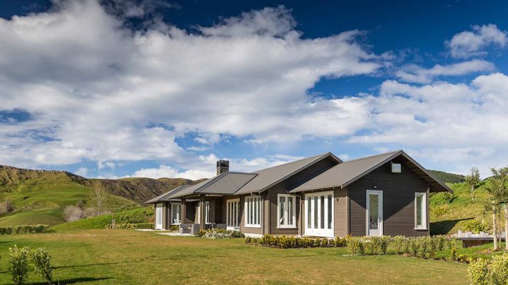 Dark grey house on green lifestyle block 