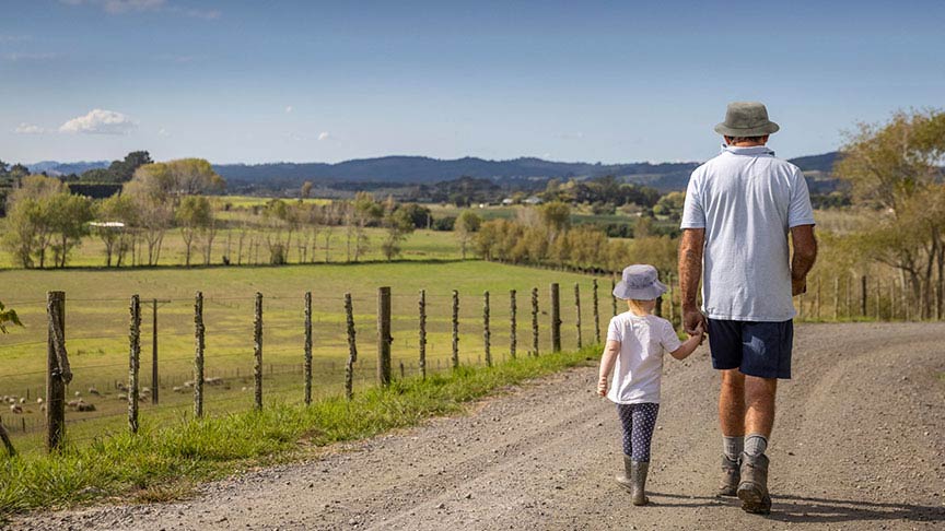grandfather walking with granddaughter wearing bucket hats 